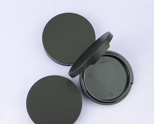 Round black compact powder case with mirror