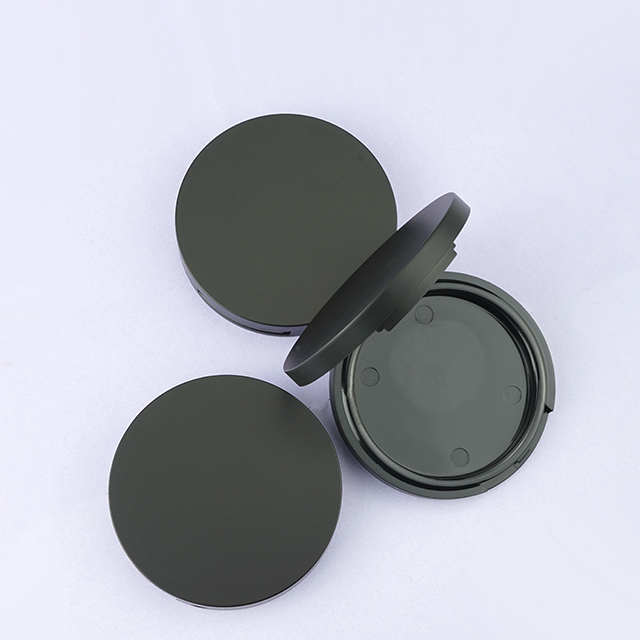 Round black compact powder case with mirror