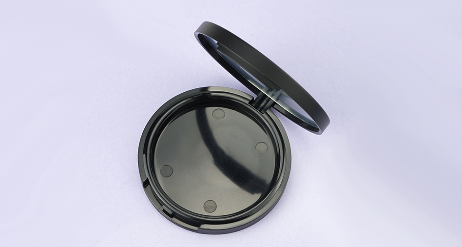 Round black compact powder case with mirror