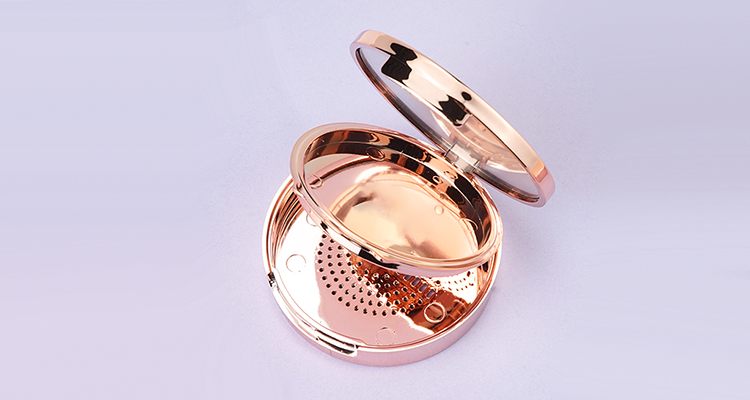 Round gold compact case with mirror