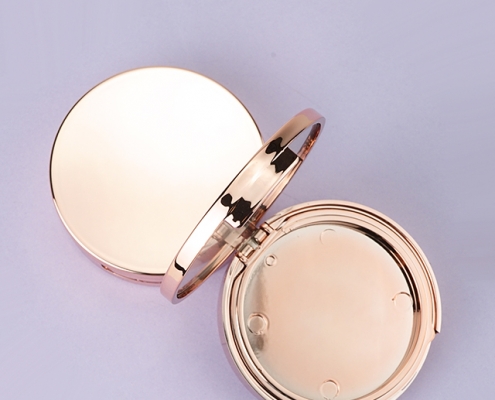 Round gold compact case with mirror