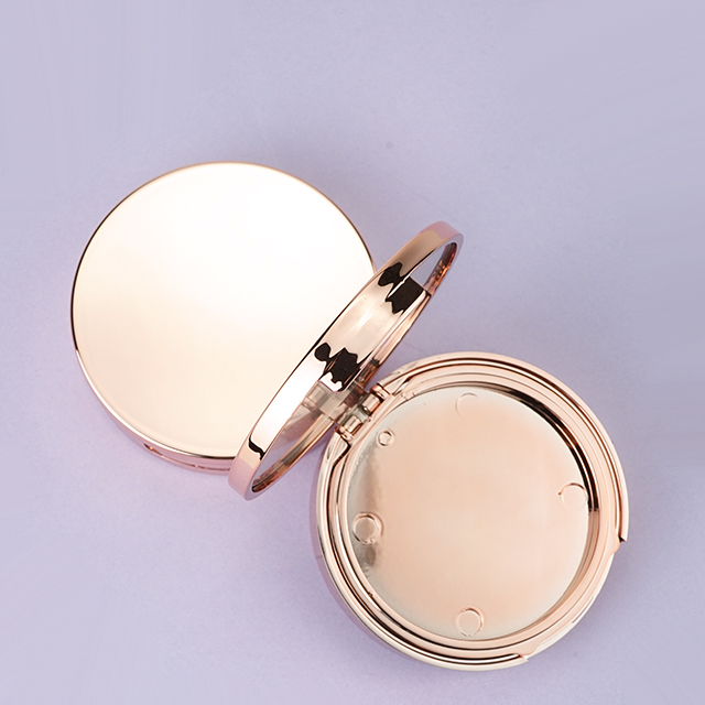 Round gold compact case with mirror